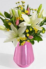 White lilies and pink tulips in a pink vase