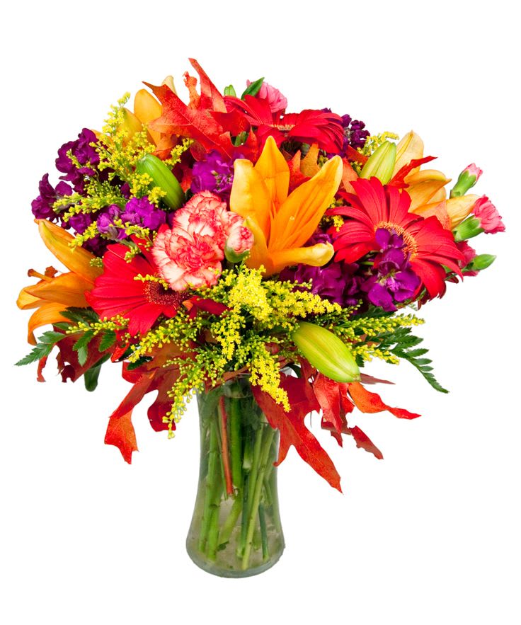 Bright mixed bouquet of lilies, gerbera daisies, and carnations in a glass vase