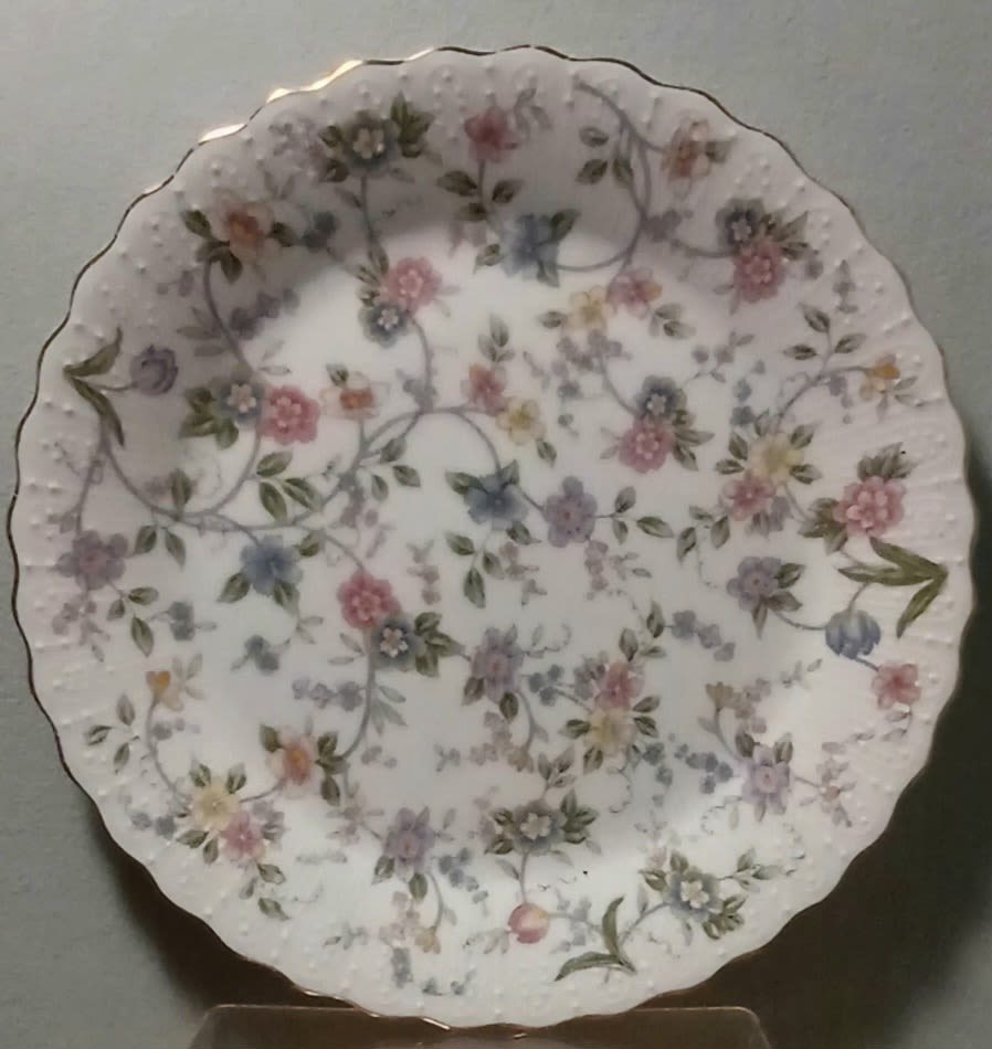 Decorative white scalloped plate with pastel floral pattern