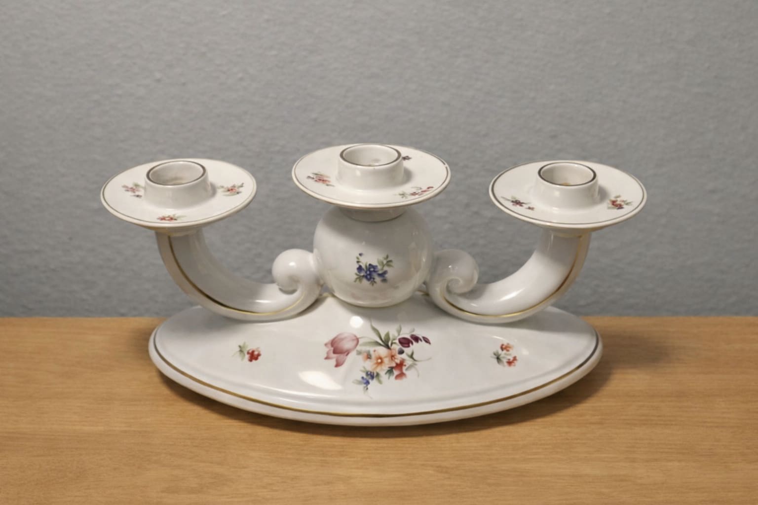 White porcelain three-arm candle holder with small floral decals