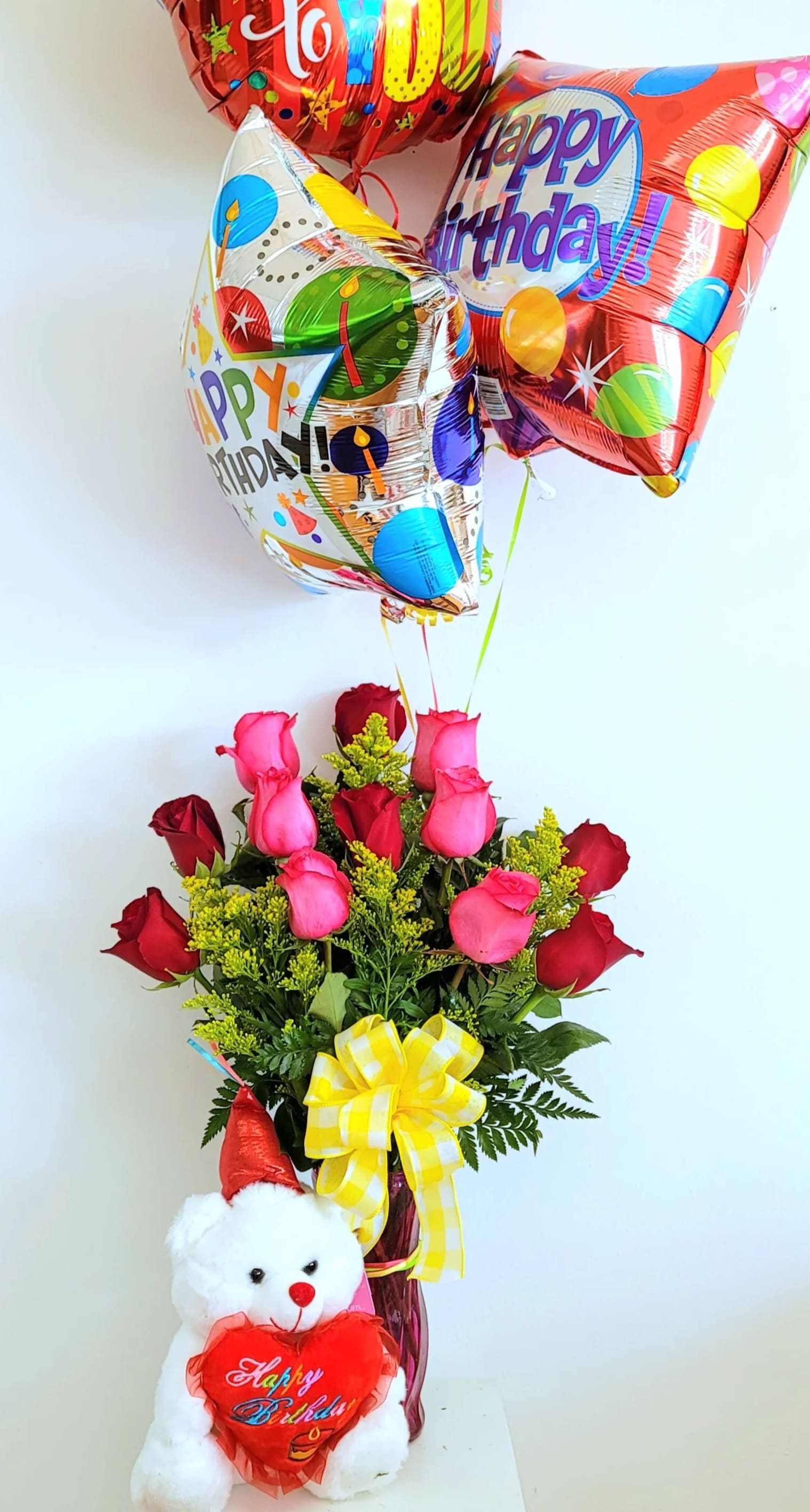 Birthday balloon bouquet with roses and a teddy bear in a vase