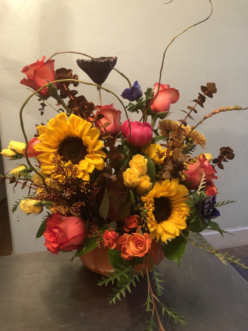 Pumpkin Centerpiece - Falling all over this Pumpkin! Seasonal flowers and filler to fill up this pumpkin for your holiday celebration, or just because! Denver Florist, LoHi Florist. Same Day Delivery if ordered before Noon Mountain Time.