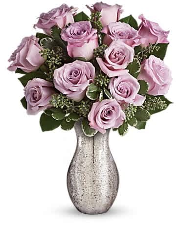 Forever Mine by Teleflora - A sparkling mercury glass vase lends a feeling of vintage romance to one dozen delicate lavender roses. It's a bouquet as timeless as your love -and one she'll always remember! Twelve lavish lavender roses are artfully accented with seeded eucalyptus and variegated pittosporum. Delivered in a silver mercury glass vase for a timeless look.