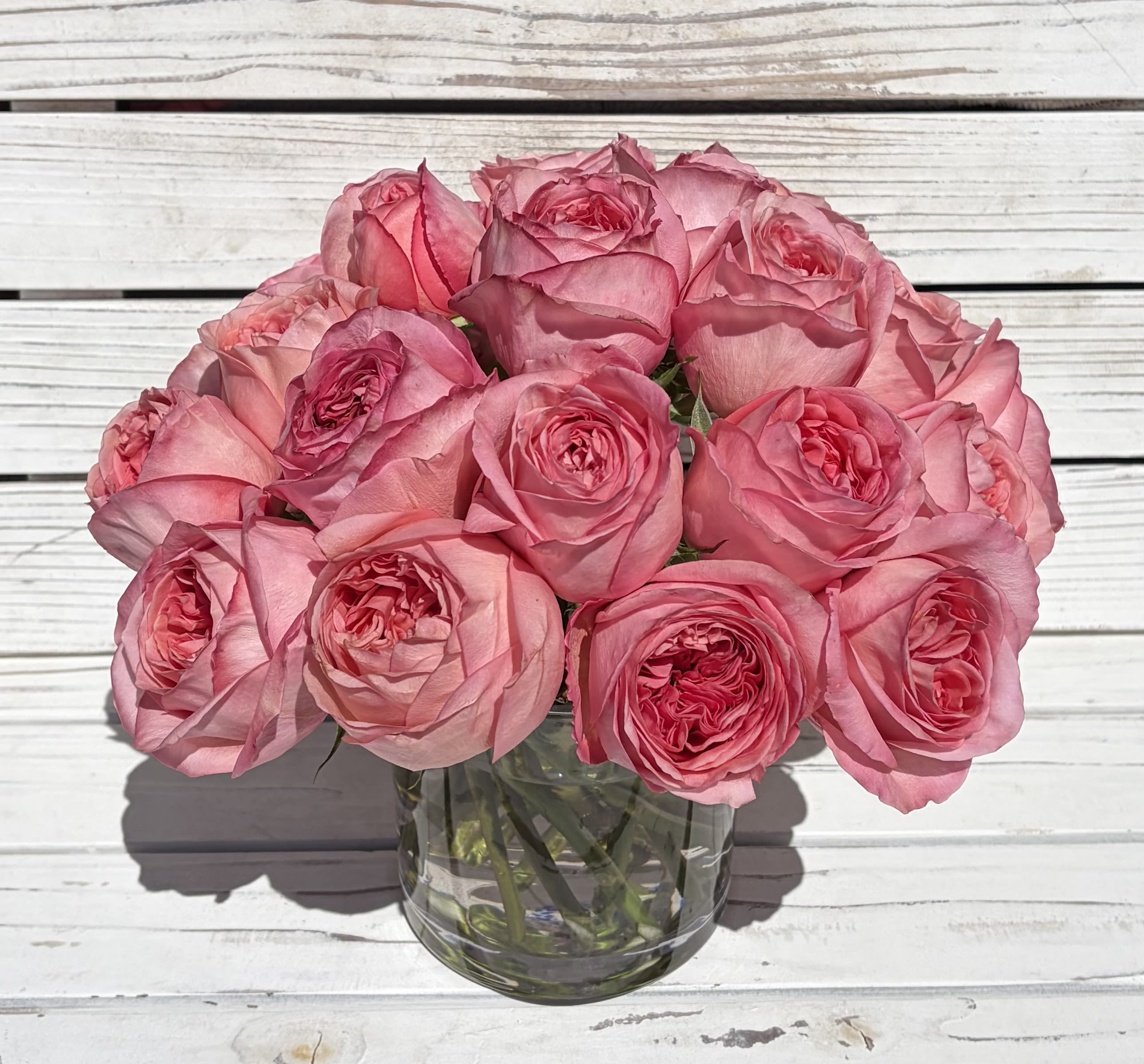 Spiral Pink Xpression Rose Pavé Arrangement - A spiral arrangement of 24 Pink Xpression roses is perfect as a birthday bouquet, anniversary gift, or a spring celebration centerpiece.  The compact, pavé-like presentation gives a polished, classic silhouette that fits on a dining table or bedside dresser.