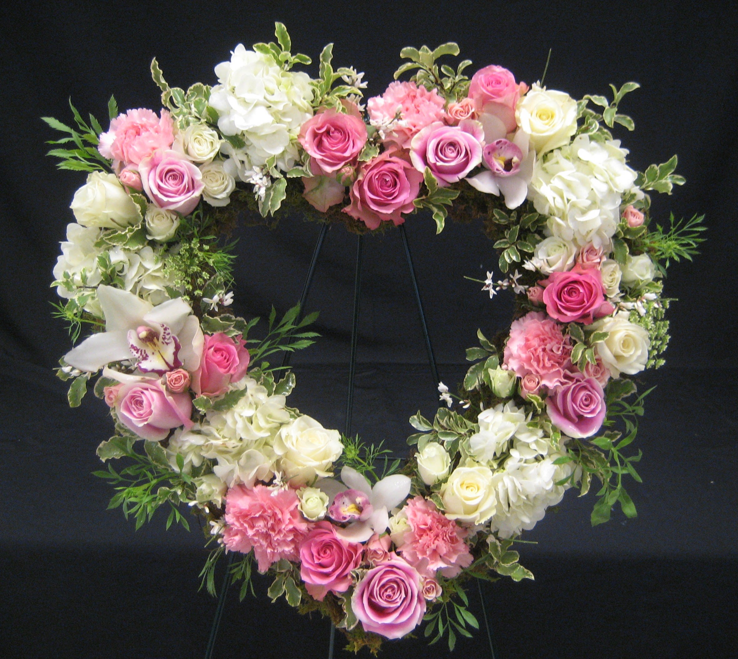 Heart-shaped floral wreath with pink and white roses and hydrangeas