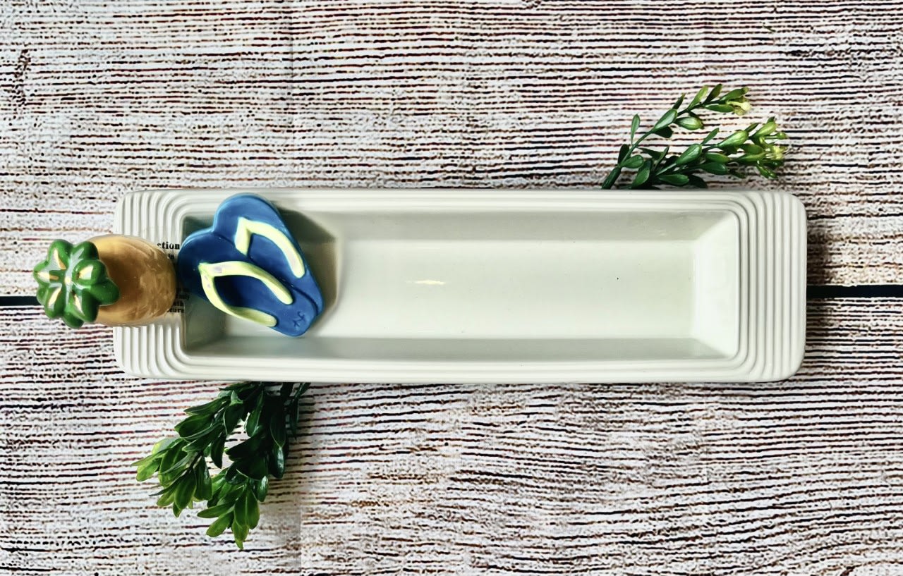 Rectangular white serving tray with a small decorative succulent and flip-flop accents