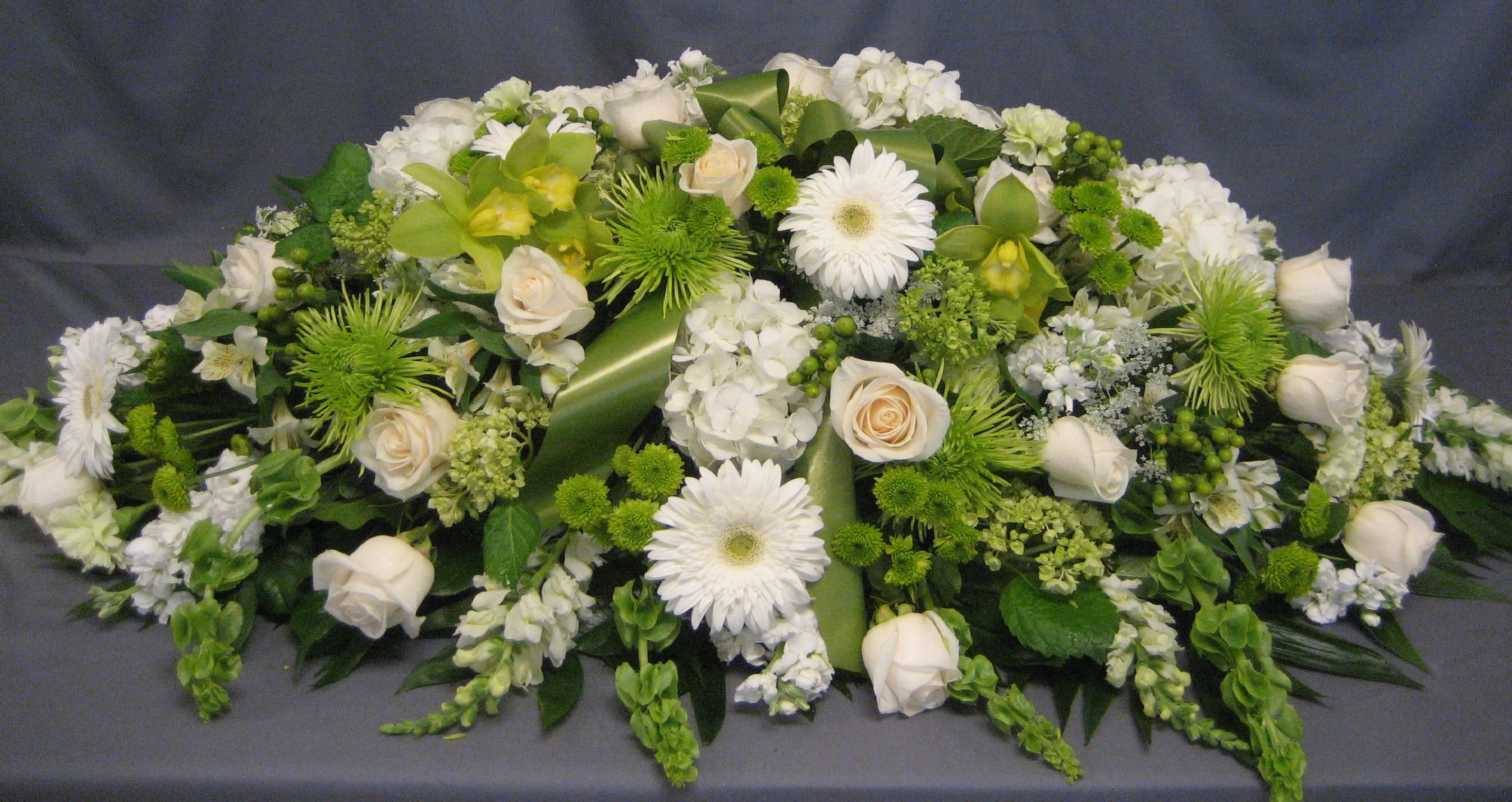 Green &amp; White Casket Spray C13 - A casket spray is the largest piece at a service and this beautiful white, and green is a lovely tribute. Upgrading to Deluxe or Premium will add more flowers to your design. **Ribbon Script is an additional $10 