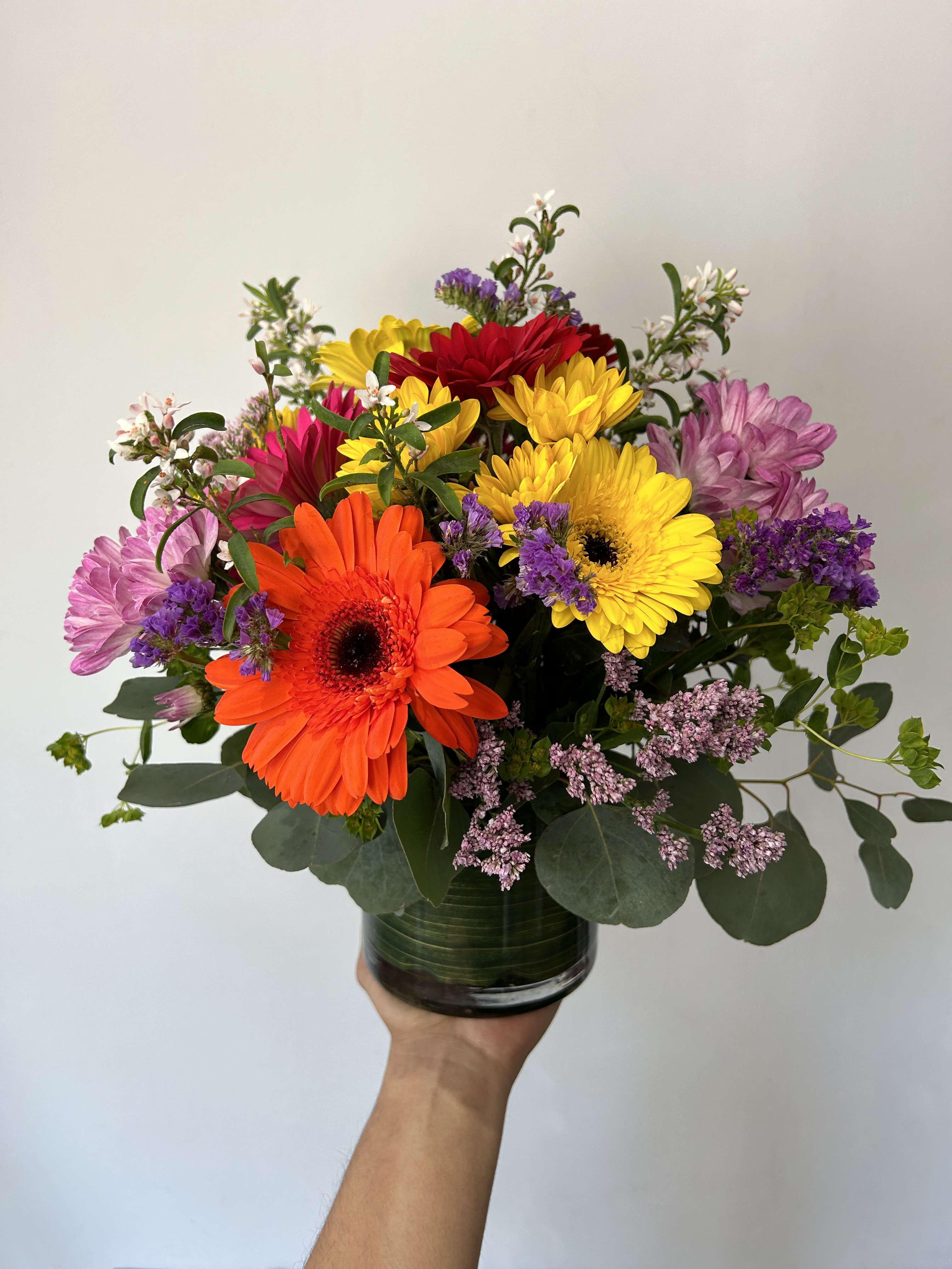 Summer Daisies  - Seasonal mix of gerbera daisies and daisies arranged with filler and greens in a vase