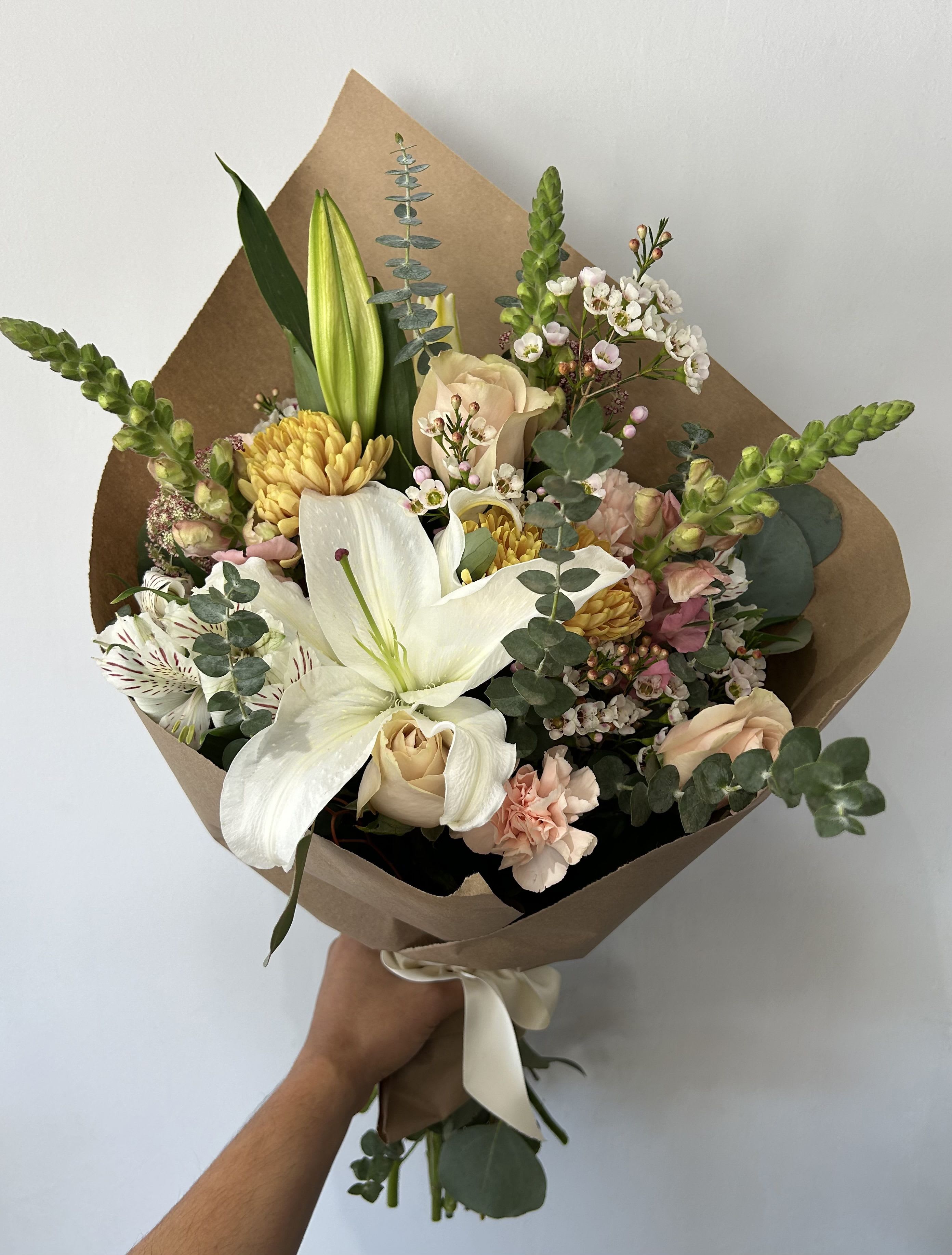 Muted Bouquet  - Seasonal light colored flowers arranged into a hand-tied bouquet. 