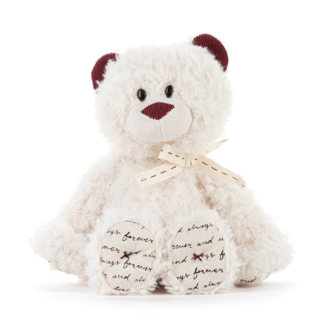 White teddy bear with burgundy ears and nose, tied with a ribbon