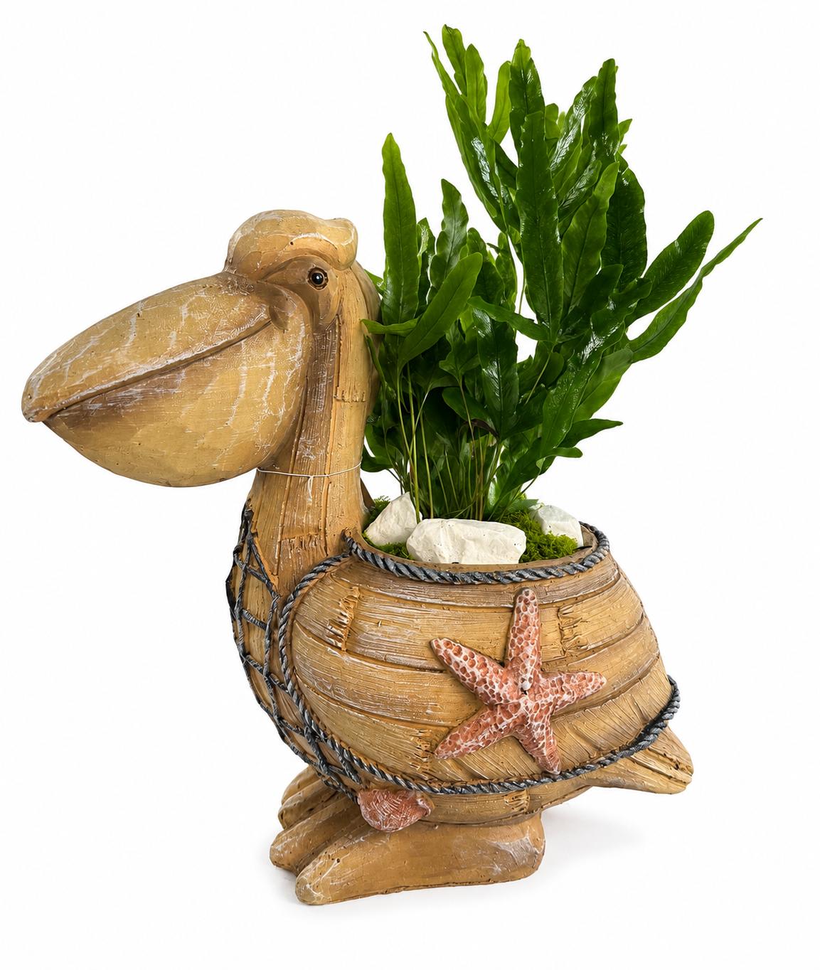 Pelican-shaped planter with green foliage and white stones
