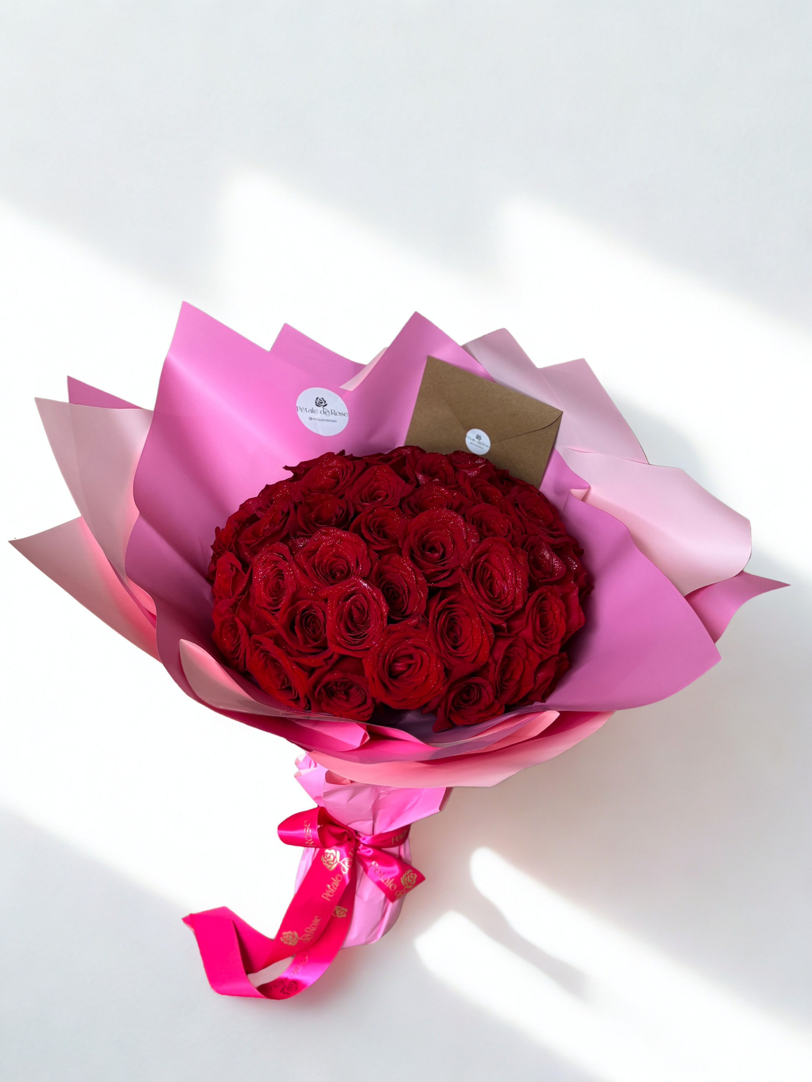 Splendid Pink &amp; Red - Red roses wrapped in pink wrapping paper   Handcrafted with love by Pétale de Rose  Same-day delivery available in Houston &amp; Katy 