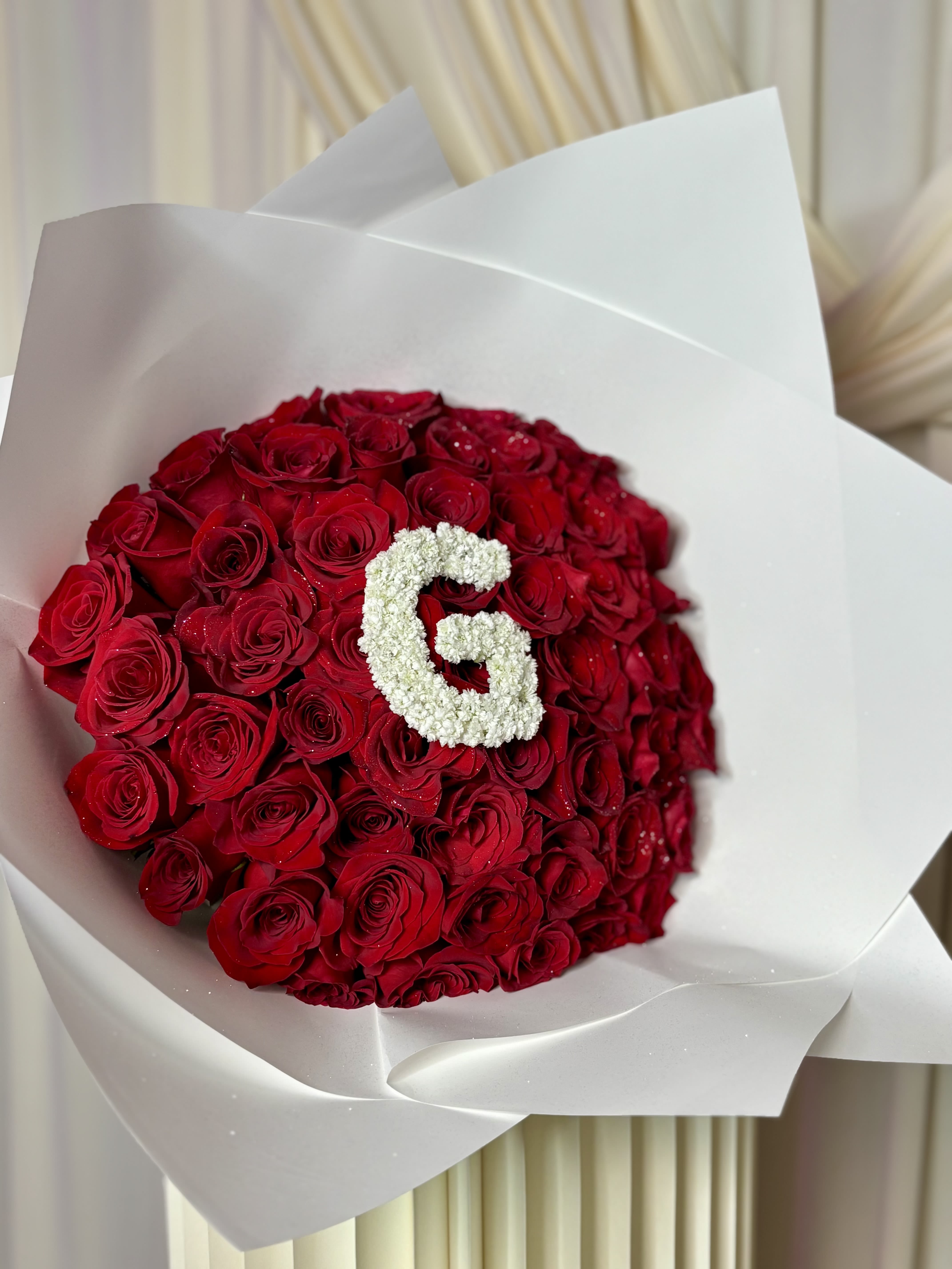 Signature Initial Bouquet  - A luxurious statement bouquet featuring premium red roses beautifully wrapped in our signature elegant presentation paper and customized with your chosen initial or number for a truly personal touch.  Perfect for birthdays, anniversaries, graduations, proposals, or celebrating someone special in an unforgettable way ️   Customization available: You may request a preferred initial or number design for the bouquet. ———Please include your desired letter or number in the Special Instructions section at checkout.