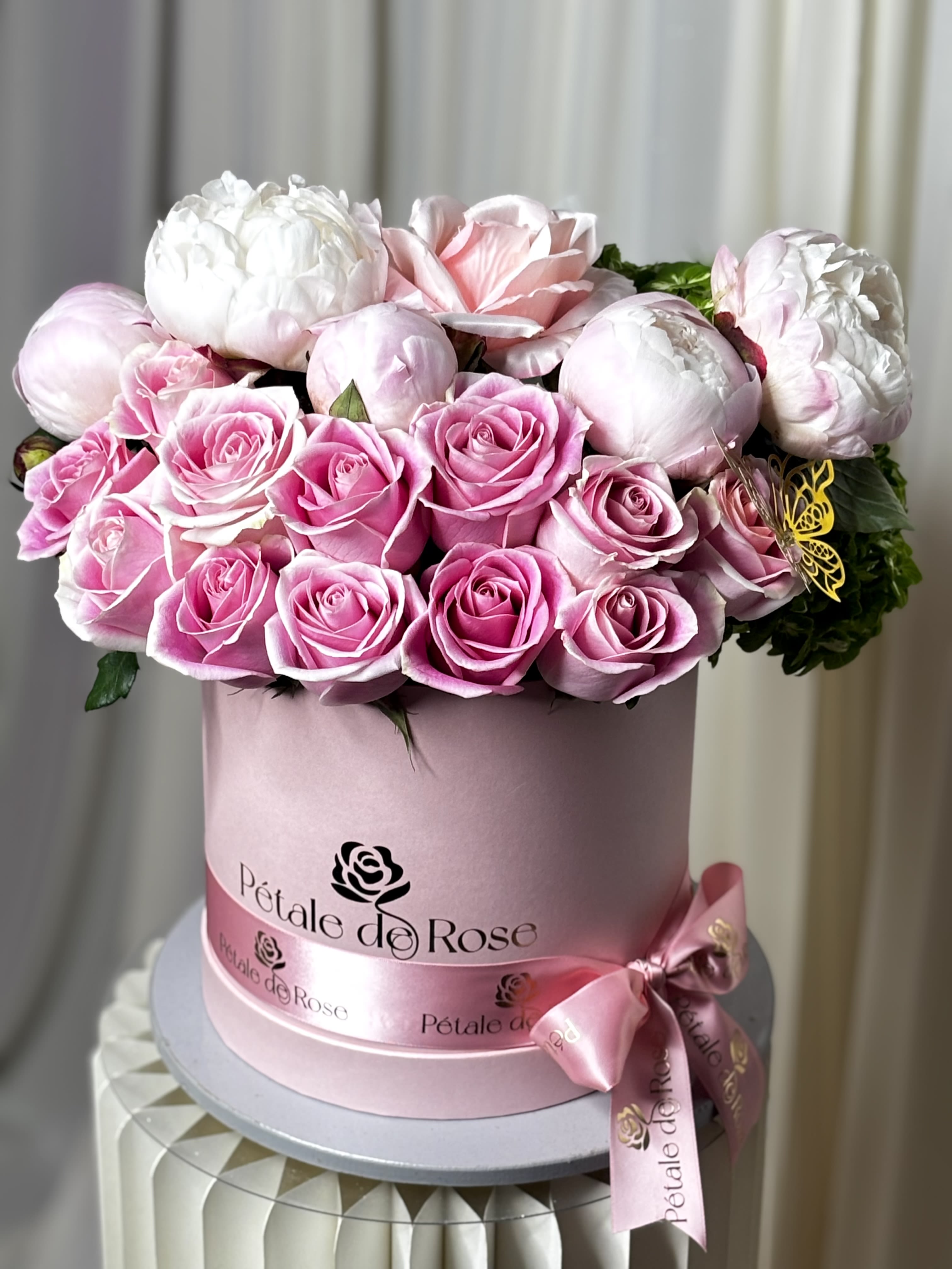 Peony Bloom - A luxurious floral box designed to celebrate Mom in the most elegant way  Featuring fresh roses, premium coral peonies, and fresh seasonal textures arranged in our signature flower box.  A romantic and sophisticated design full of beauty, fragrance, and charm   • Fresh premium flowers • Designed in our signature box • Limited seasonal peonies available  (Please note: Flower substitutions and shades may vary based on seasonal and market availability. Our designers will always maintain the overall color palette, freshness, style, and luxurious feel of the arrangement shown.) 