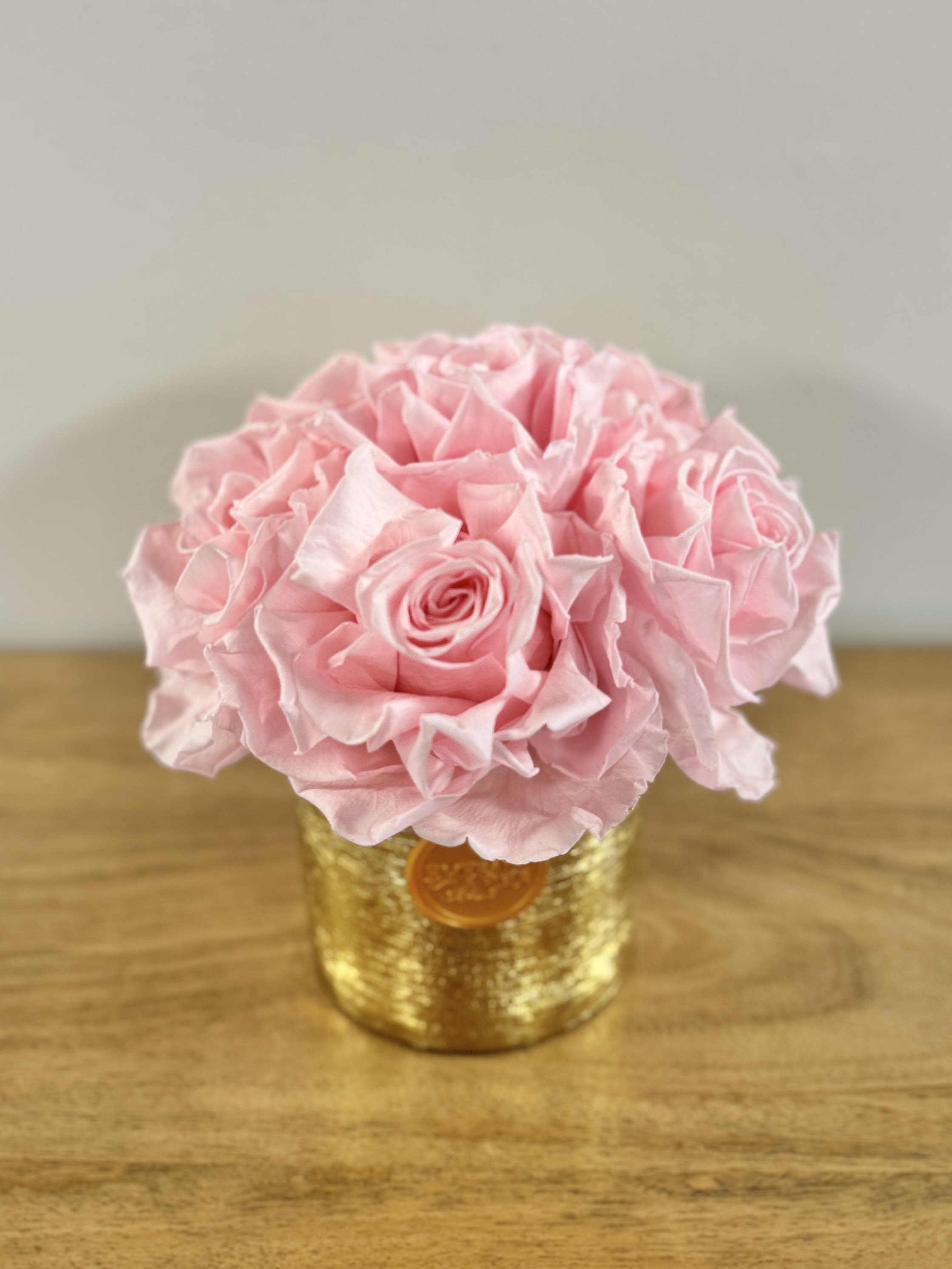 Pink rose bouquet in a gold textured container