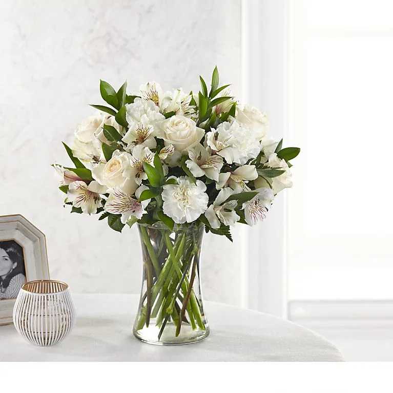 White roses and alstroemeria in a clear glass vase