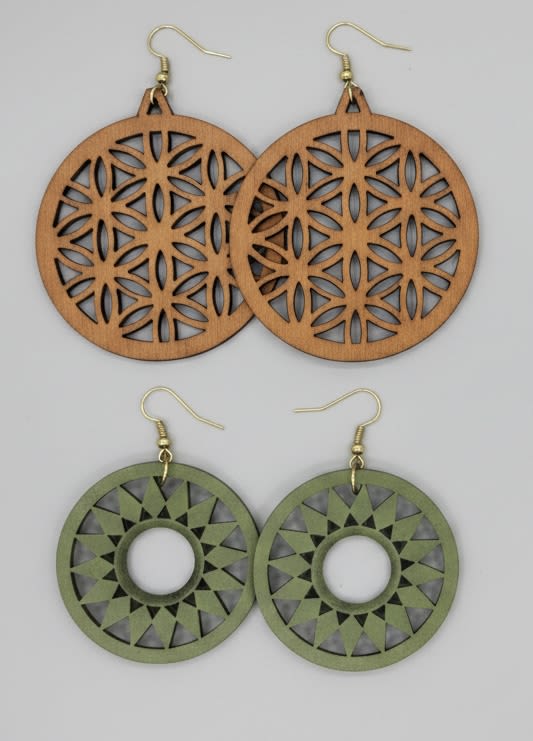 Round wooden flower of Life earrings set - Handcrafted wooden dangle earrings bring an earthy, artful touch to every "just because" moment - perfect as a birthday gift, anniversary surprise, or a small way to say "thinking of you." These round, laser-cut earrings pair geometric Flower of Life patterns with a warm, natural vibe that reads romantic yet relaxed, making them a sweet choice for Mother's Day, Valentine's Day, or to celebrate a close friend.  One pair shows natural wood grain in a large circular design; the other is painted olive green with a crisp open center for contrast. Both are lightweight with delicate laser-cut detailing and simple gold-tone metal hooks for comfortable all-day wear. The handcrafted look feels artisanal and timeless without being precious, so they suit spring wardrobes and everyday outfits alike.  Give them to someone who appreciates subtle symbolism and natural materials - they arrive ready to gift and are easy to care for: avoid prolonged moisture and store flat to preserve the wood finish. These earrings make a thoughtful way to say thank you, I love you, or I'm thinking of you.