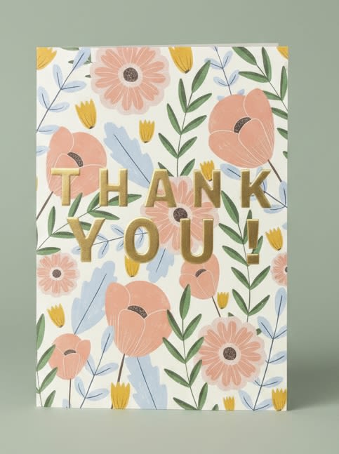 Thank You card - A cheerful, illustrated thank-you card that feels like a little bouquet in paper form - perfect as a gift accompaniment or an everyday appreciation note. This vertical greeting card pairs large gold "THANK YOU!" lettering with a soft floral pattern, making it an ideal pick for a birthday thank-you, hostess note, teacher appreciation, or just to say you're thinking of someone special.  The card's artwork shows stylized pink daisy-like blooms, small yellow buds, and blue-green leafy stems on a clean white field, giving a feminine, handmade look that complements pink, white, green, or yellow floral arrangements. Blank inside for your personal message and sized to tuck into a bouquet or gift box, it sends a bright, sincere message that will make the recipient feel noticed and appreciated.