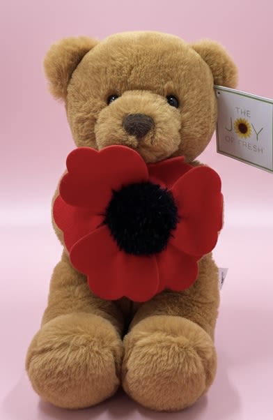 The Poppy Bear - A cuddly tan plush teddy bear clutching a bold red stylized flower makes a playful, affectionate gift for love and romance or a cheerful "thinking of you" surprise. This flower arrangement-style keepsake pairs soft texture with graphic color-bright red petals and a dark center against a soft pink backdrop-to create an immediate emotional impact that reads romantic for Valentine's Day, sweet for birthdays, and gently uplifting for get-well wishes.  The Poppy Bear includes a fuzzy seated teddy, a single large decorative red bloom with a black center, and a small product tag-an easy, no-fuss gift that looks thoughtfully composed without needing water or vase care. The compact presentation fits on a bedside table or desk and delivers a tactile, visual message: warmth, comfort, and attention.  Perfect for the person who prefers lasting keepsakes over fresh flowers, this piece says "I'm thinking of you" with a wink of romance and a comforting hug. Order as a birthday surprise, a Valentine's accent, a get-well pick-me-up, or a simple just-because treat-no special care required beyond placing it where the recipient will smile.