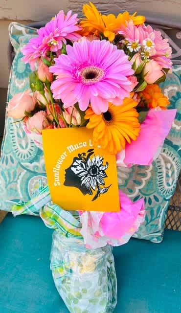 Bouquet of pink and orange gerbera daisies with pale roses and a card