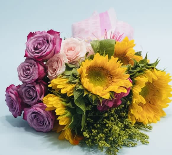 Bouquet of purple roses, pale pink roses, and yellow sunflowers