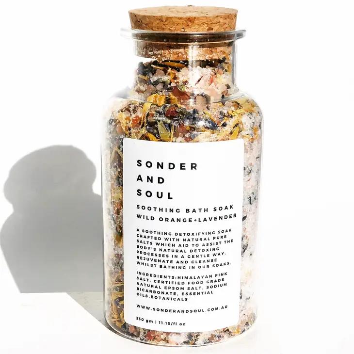 Glass jar of bath soak with cork lid and white label