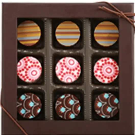 Box of assorted decorated chocolates with striped and patterned tops