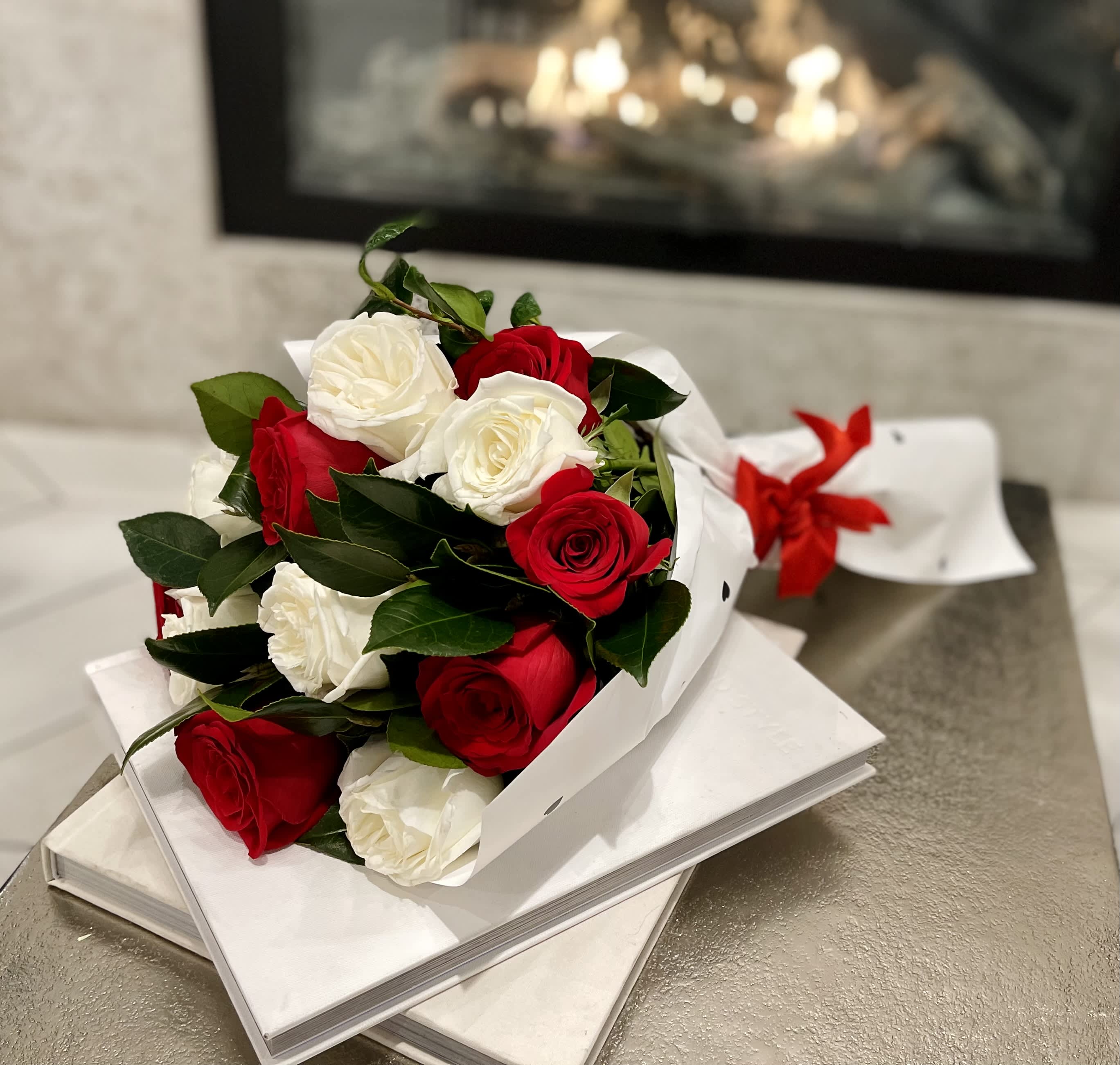 Bouquet of red and white roses wrapped in white paper