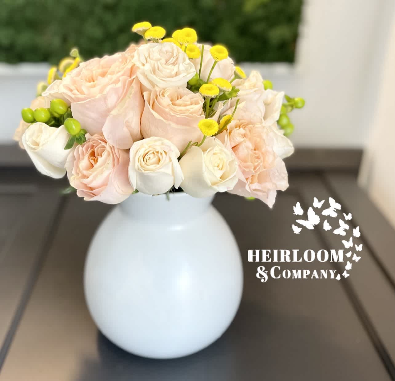 Blush and white rose bouquet in a white vase
