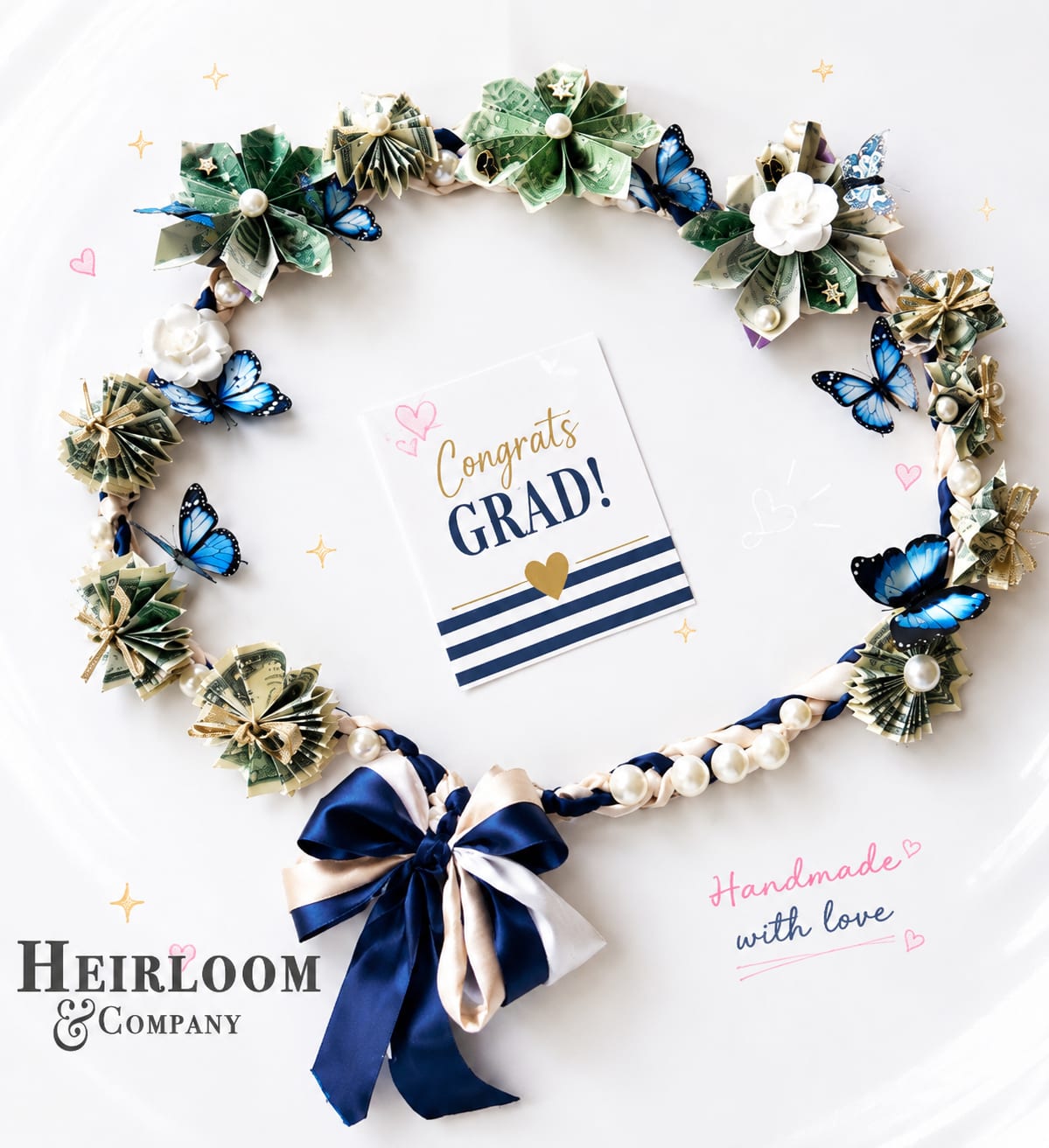 Graduation Money Lei with  - Please note colors and accents can be customized   Handcrafted from real folded paper money, this graduation money lei is a playful, celebratory take on the classic graduation garland-perfect for a graduation gift or party accessory that says "congrats" with flair. The design reads festive and polished: rosette-like clusters of folded bills form a circular wreath or wearable lei, with a small center card that cheerfully declares "Congrats Grad!" so the recipient feels recognized the moment they put it on.  Blue butterfly accents, white pearl-like beads, and a navy-and-cream satin ribbon bow lift the palette-navy, bright blue, white and soft green from the bills-into something both whimsical and refined. The layered, handmade construction gives the piece texture and movement; butterflies and pearls catch the light while the satin ribbon ties the look together. A matching satin ribbon tail and included greeting card complete the presentation, making it easy to gift right from the box.  Designed for graduates of any age who like a little sparkle, this money lei works as a wearable keepsake at a commencement, party, or photo moment and doubles as a practical present. Gentle handling is recommended to keep the folded bills and decorative beads neat; store flat or hang by the ribbon when not wearing.