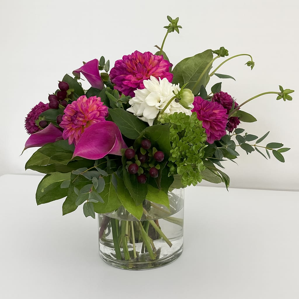 Dahlia Field - This arrangement is presented in a white/brown terracotta vase. It features dark pink color dahlias, white dahlias and calla lily. It's a prefect early fall gift. 
