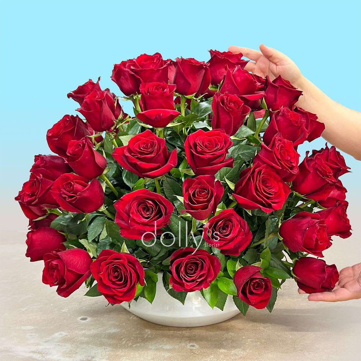 Rose Quartz | 72 Long-Stem Red Roses  - An architectural marvel of deep, velvet crimson.  Indulge in the intensity of absolute devotion. The Passionate Ward is an immersive, 360-degree sphere composed of 72 premium, long-stemmed red roses, curated for those who demand more than a bouquet—they demand a statement. Each rose is hand-selected for its high petal count and saturated, velvety hue, meticulously arranged to create a seamless, breathtaking orb of color.  Beyond its striking form, this piece serves as a sanctuary for your most profound sentiments. It is a bold, structural embodiment of passion, designed to command a room and capture the fleeting magic of mid-summer romance. This is not merely an arrangement; it is a grand, botanical guardian of your deepest emotions—a permanent symbol of love that knows no bounds.