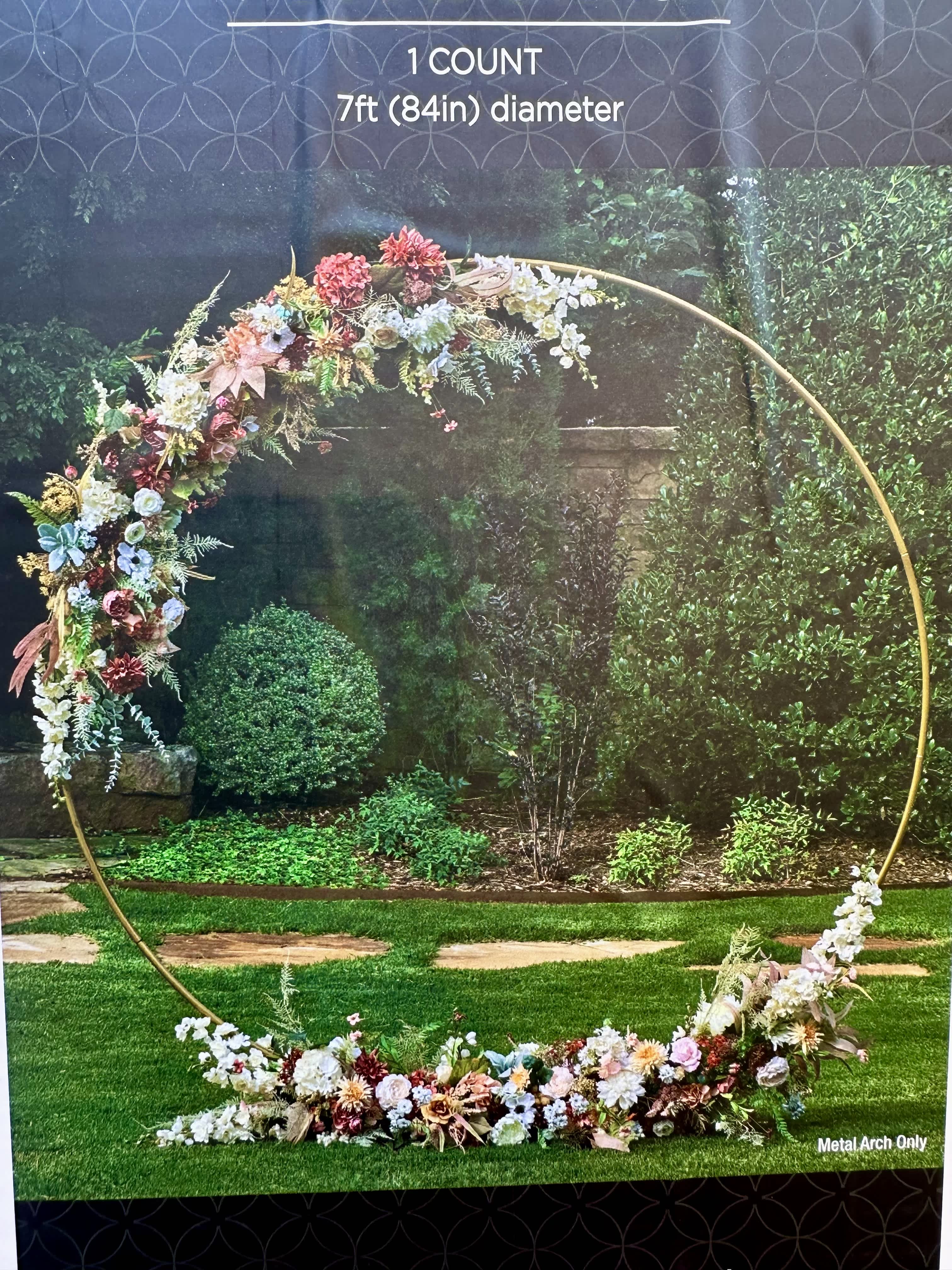 Floral arch arrangement on a gold metal hoop with pastel flowers