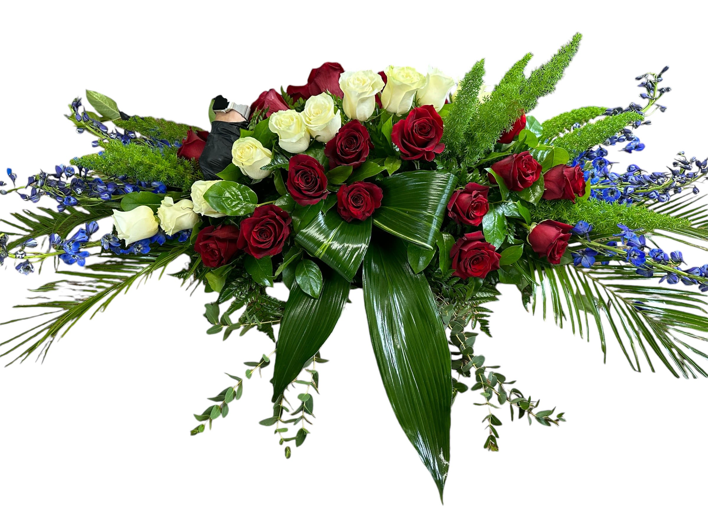 Long floral spray of red and white roses with blue accents
