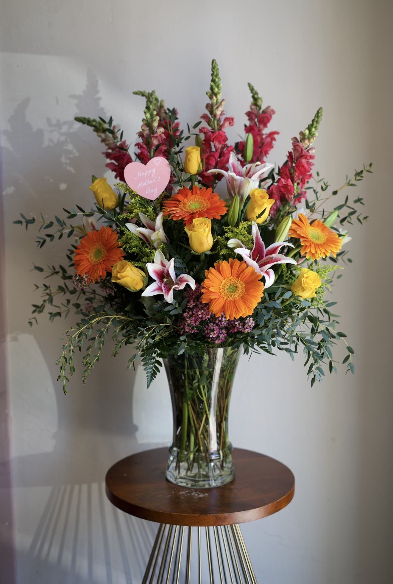 Deluxe - Designer's Choice - A lush, abundant arrangement designed to celebrate her love in the most beautiful way. Featuring premium seasonal blooms thoughtfully arranged in a full, elegant style, this bouquet is rich in texture, color, and fragrance. Its generous size and graceful design make it a stunning centerpiece