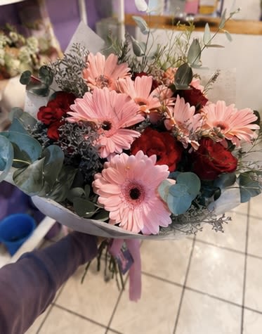 Pink Gerbera &amp; Red Rose Bouquet - A soft, romantic hand-tied bouquet of blush pink gerberas, deep red roses, and eucalyptus sprigs, wrapped in muted grey paper with a lavender ribbon. Beautiful for birthdays, thank-you gifts, or just because.