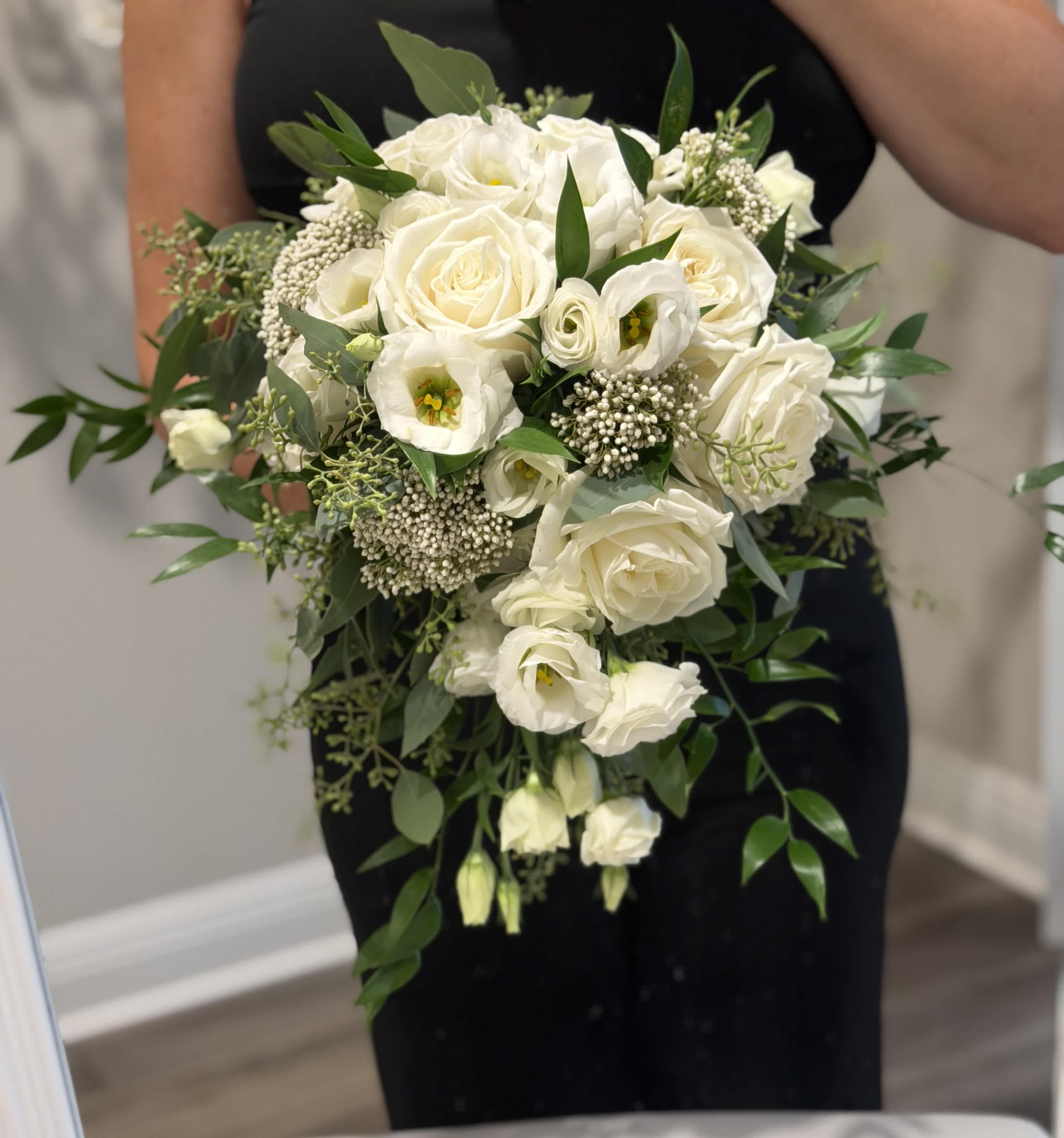 White rose and lisianthus bouquet with greenery