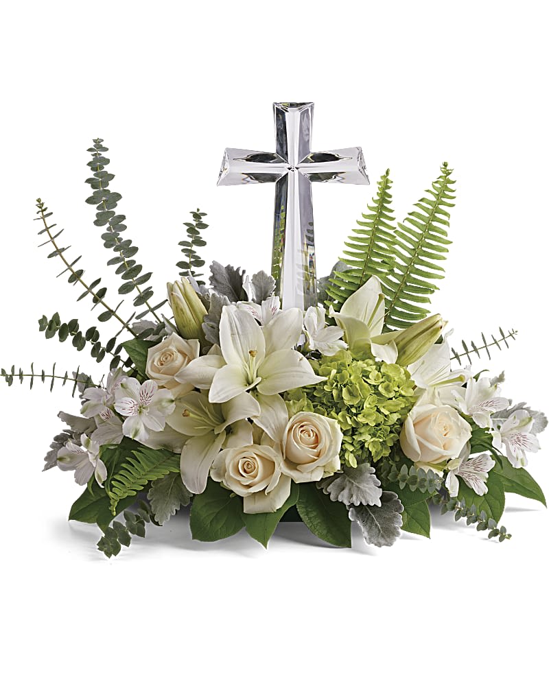Life's Glory Bouquet by Teleflora - This peaceful bouquet of soft white flowers and green accents is a beautiful message of sympathy, adorned with a large crystal cross keepsake. Green hydrangea, crÃ¨me roses, white asiatic lilies, and white alstroemeria are accented with dusty miller, sword fern, spiral eucalyptus, and lemon leaf. Delivered with a Large Crystal Cross Keepsake.