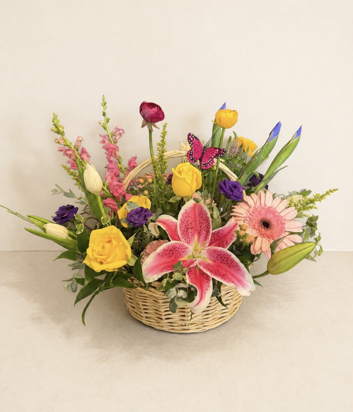 Mixed flower basket with pink lily, yellow roses, and gerbera daisies
