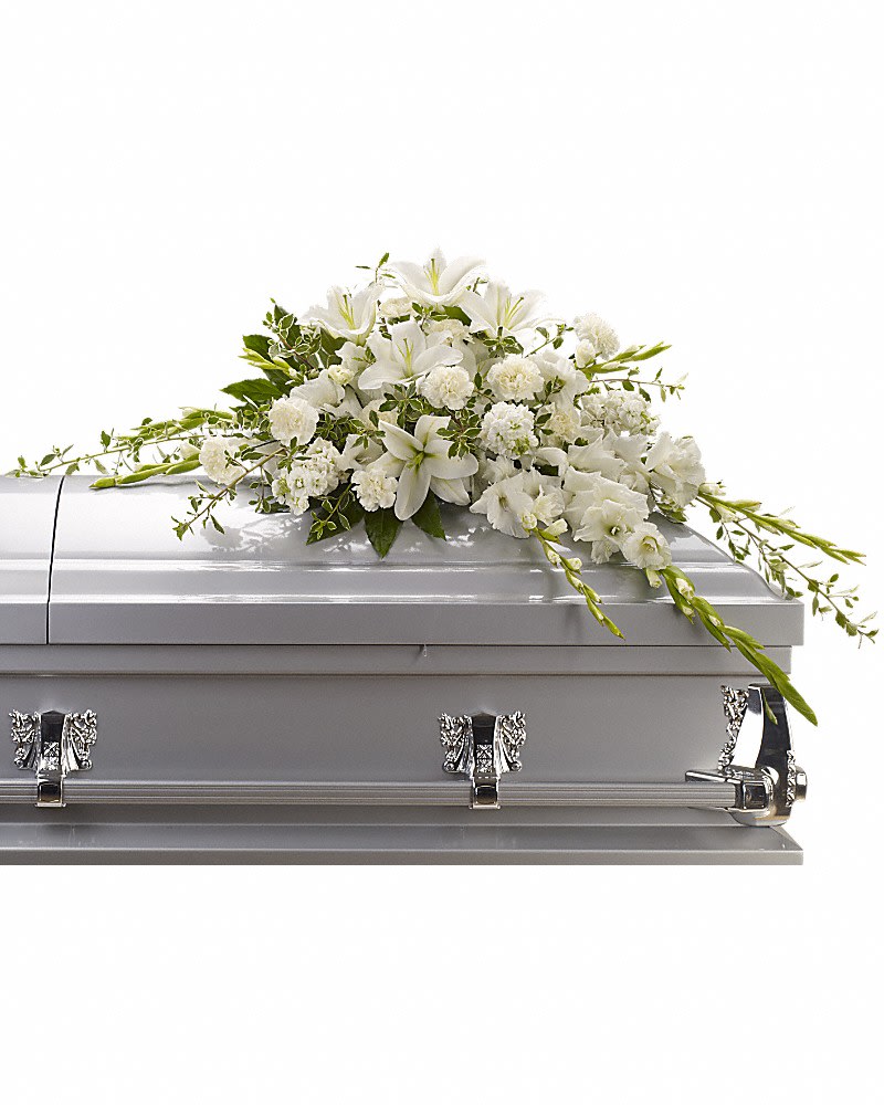 Bountiful Memories Casket Spray - A casket spray made of all white flowers and simple greenery is a simply stunning way to honor the deceased while bringing a quiet strength and serenity to those present. Gorgeous white oriental lilies, gladioli, carnations and more create a beautiful crescent shaped casket spray.