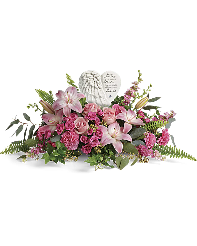 Teleflora's Heartfelt Farewell Bouquet - A heartfelt celebration of a truly special life, this magnificent bouquet of pink roses and lilies beautifully surrounds a touching porcelain keepsake they'll treasure forever. This heartfelt bouquet includes pink roses, pink spray roses, pink asiatic lilies, pink carnations, pink larkspur, green ivy, seeded eucalyptus, silver dollar eucalyptus, and sword fern. Delivered with a Heaven's Heart Keepsake.