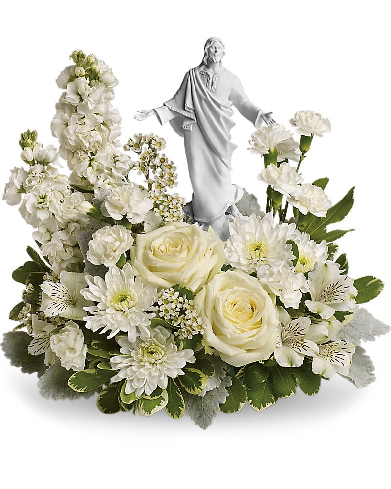 Teleflora's Forever Faithful Bouquet - An elegant display of faith and grace, this beautiful arrangement will comfort the bereaved in a truly thoughtful and respectful way. An exquisite sculpture of Jesus is surrounded by a bed of lovely blossoms. It is sure to be appreciated and always remembered. A fragrant mix of pure white blooms - including roses, alstroemeria, stock, carnations and waxflower - is accented with dusty miller and variegated pittosporum. Delivered with an exclusive Sacred Grace keepsake.