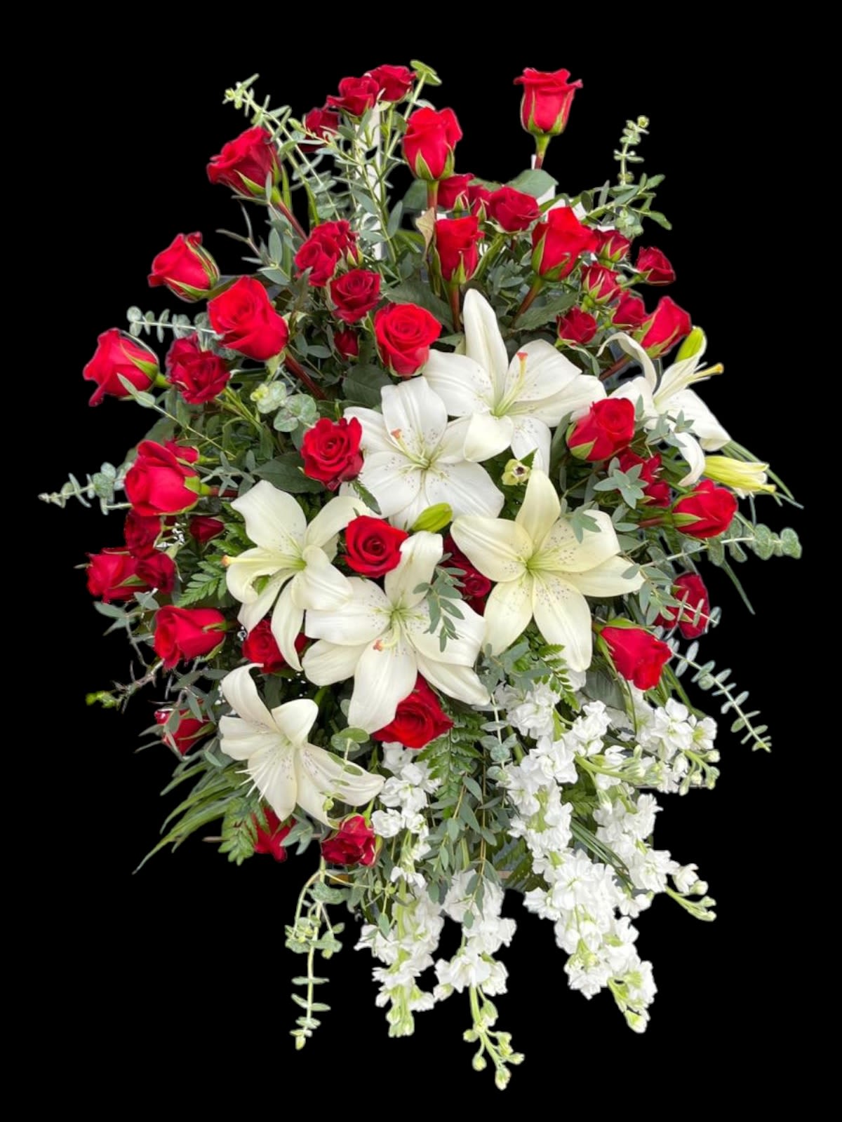 Red roses and white lilies arranged in a large bouquet