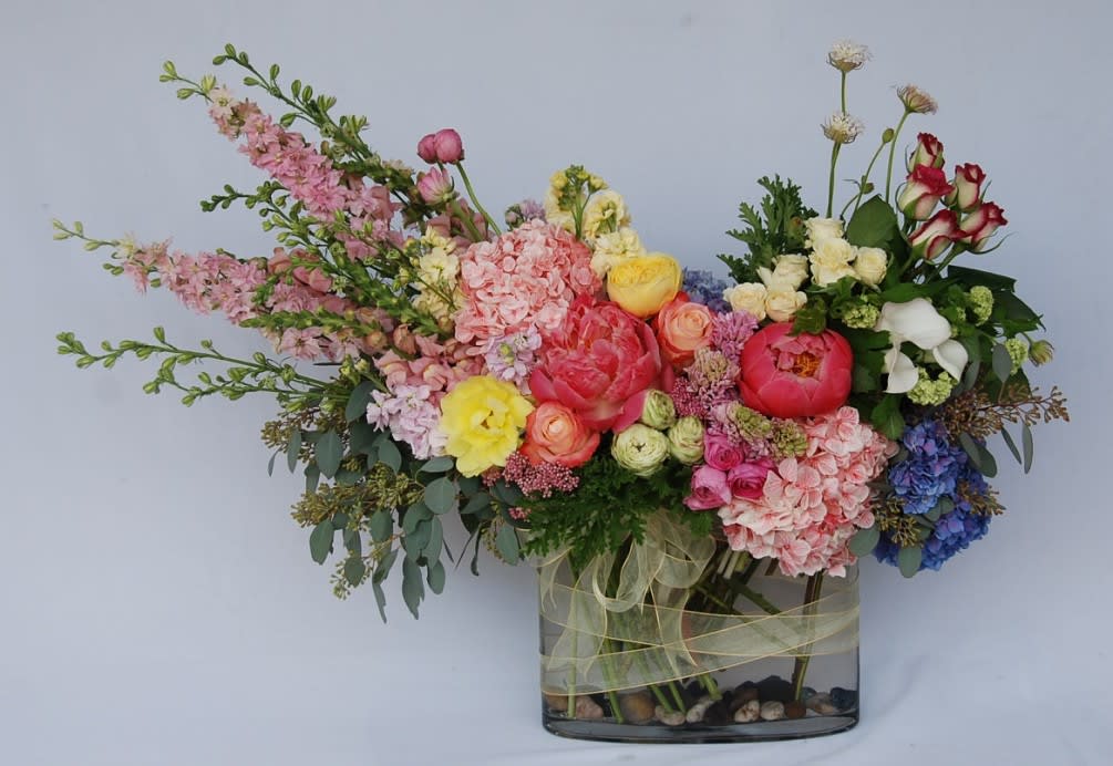 Sunland CA Flowers - A lush spring arrangement of hydrangeas, peonies, roses, spray roses, calla lilies, garden roses, larkspur, snapdragons, hyacinth, ranunculus, and stock in glass vase. 