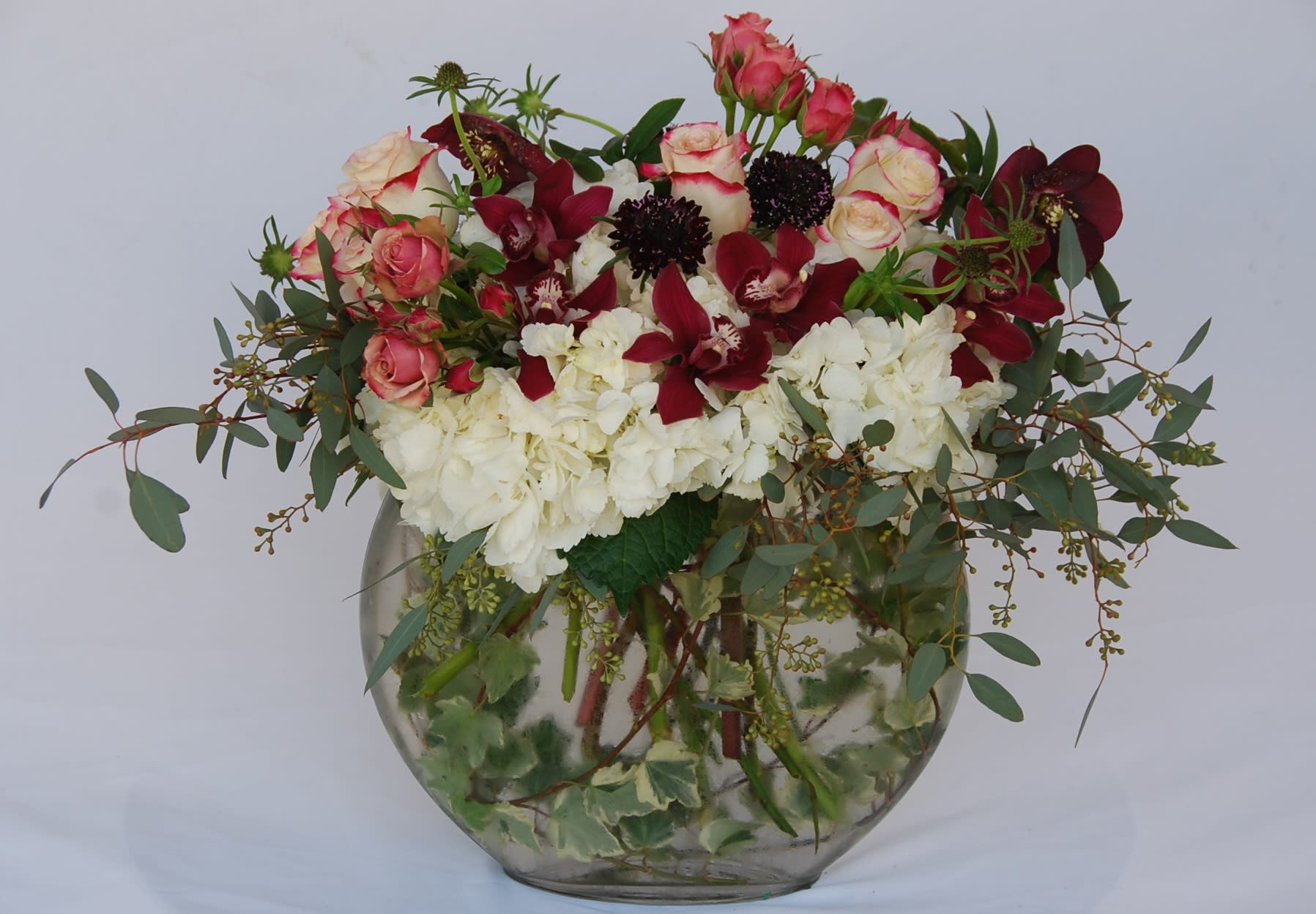 Cymbidium Orchid Vase - Oval vase with Orchids, Hydrangeas, spray roses, regular roses, scabiosa and hellebore