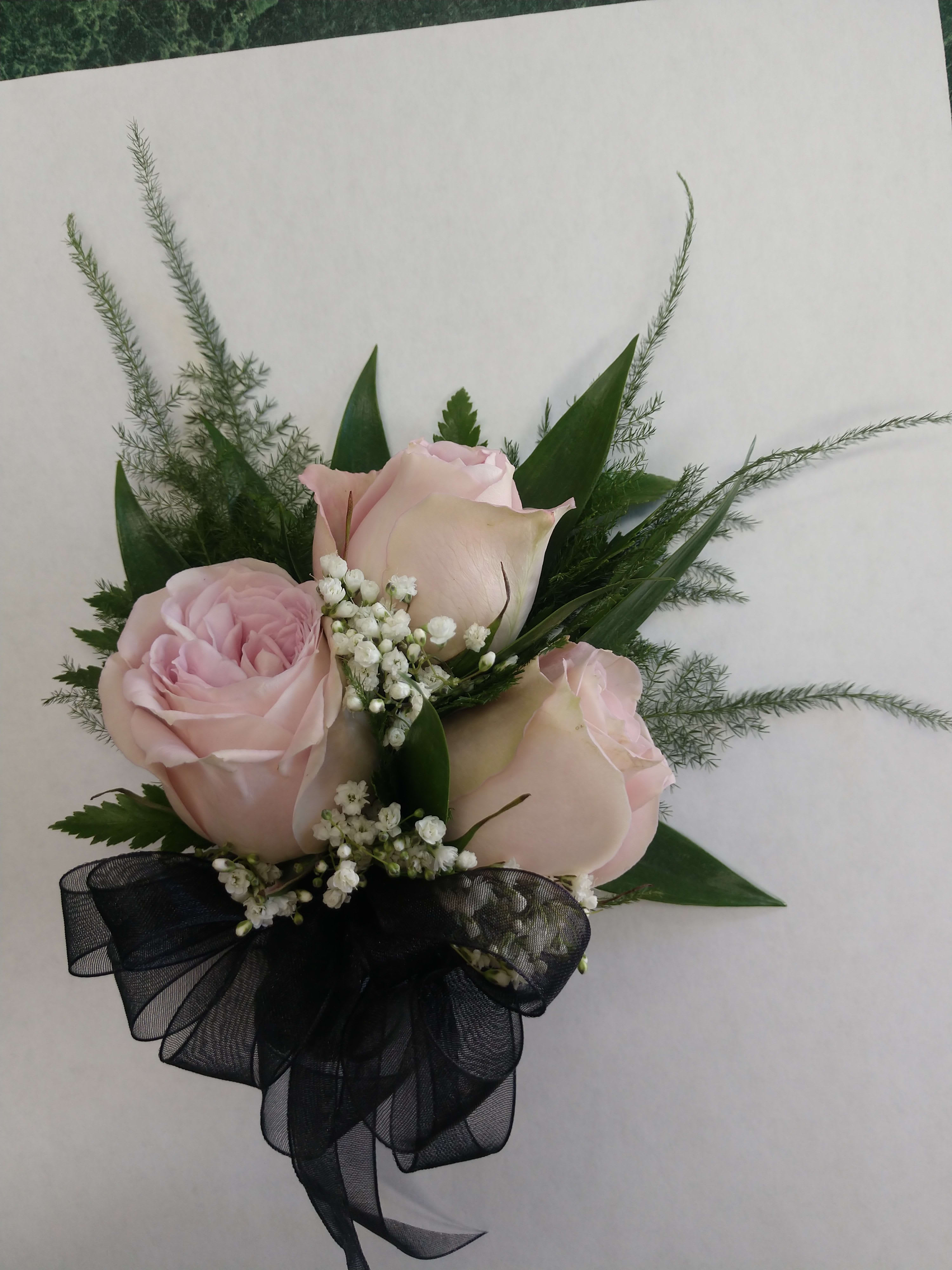 Pink roses with baby's breath and a black ribbon bow