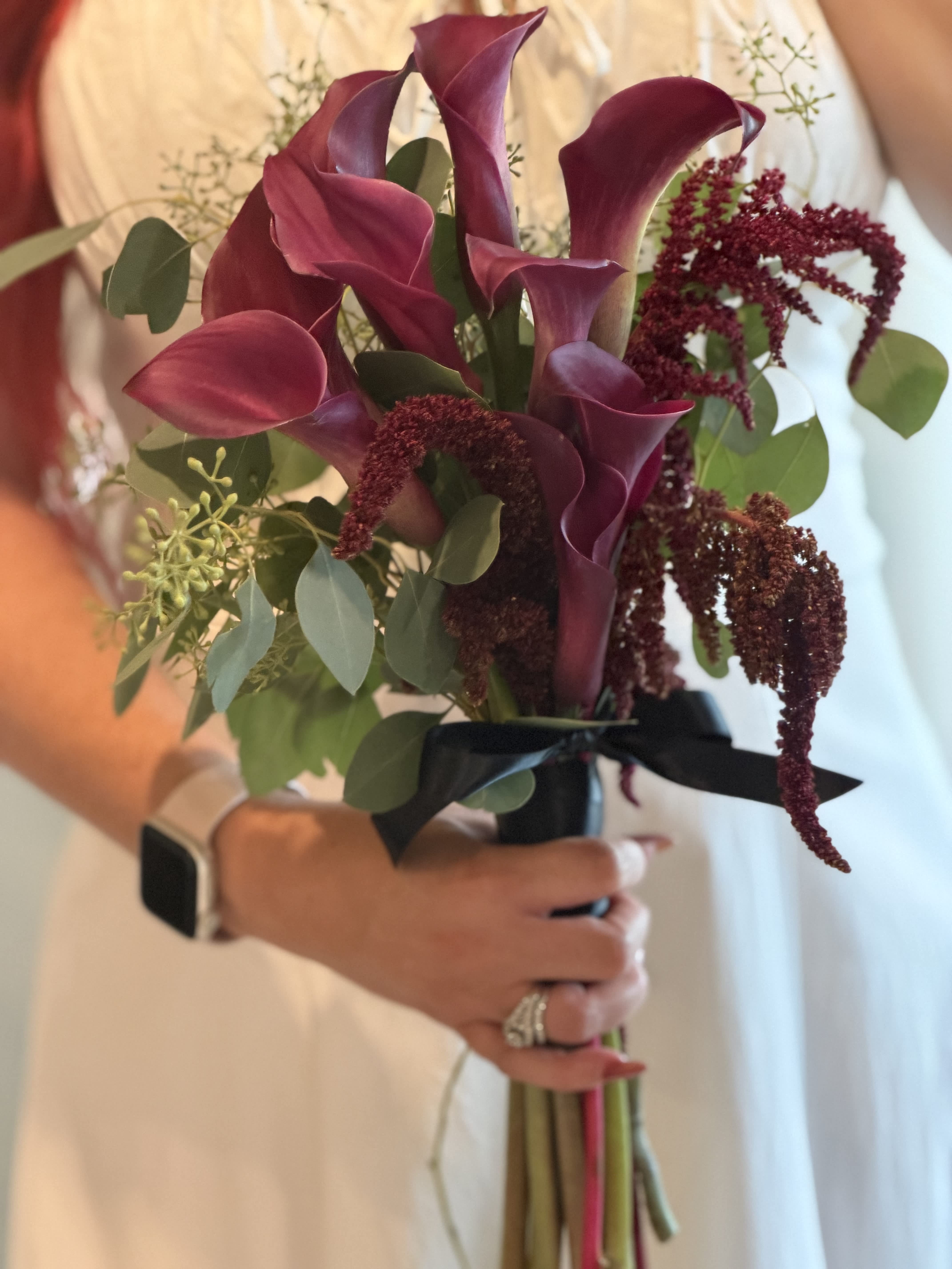 Bouquet of burgundy calla lilies with eucalyptus