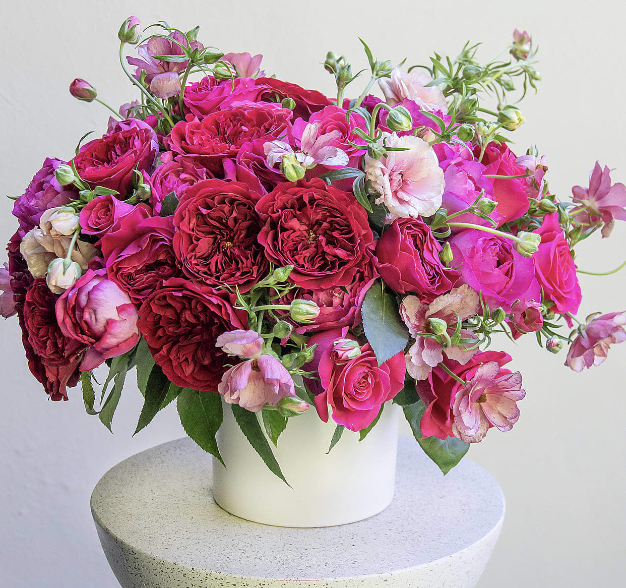Pink and red rose bouquet in a white vase