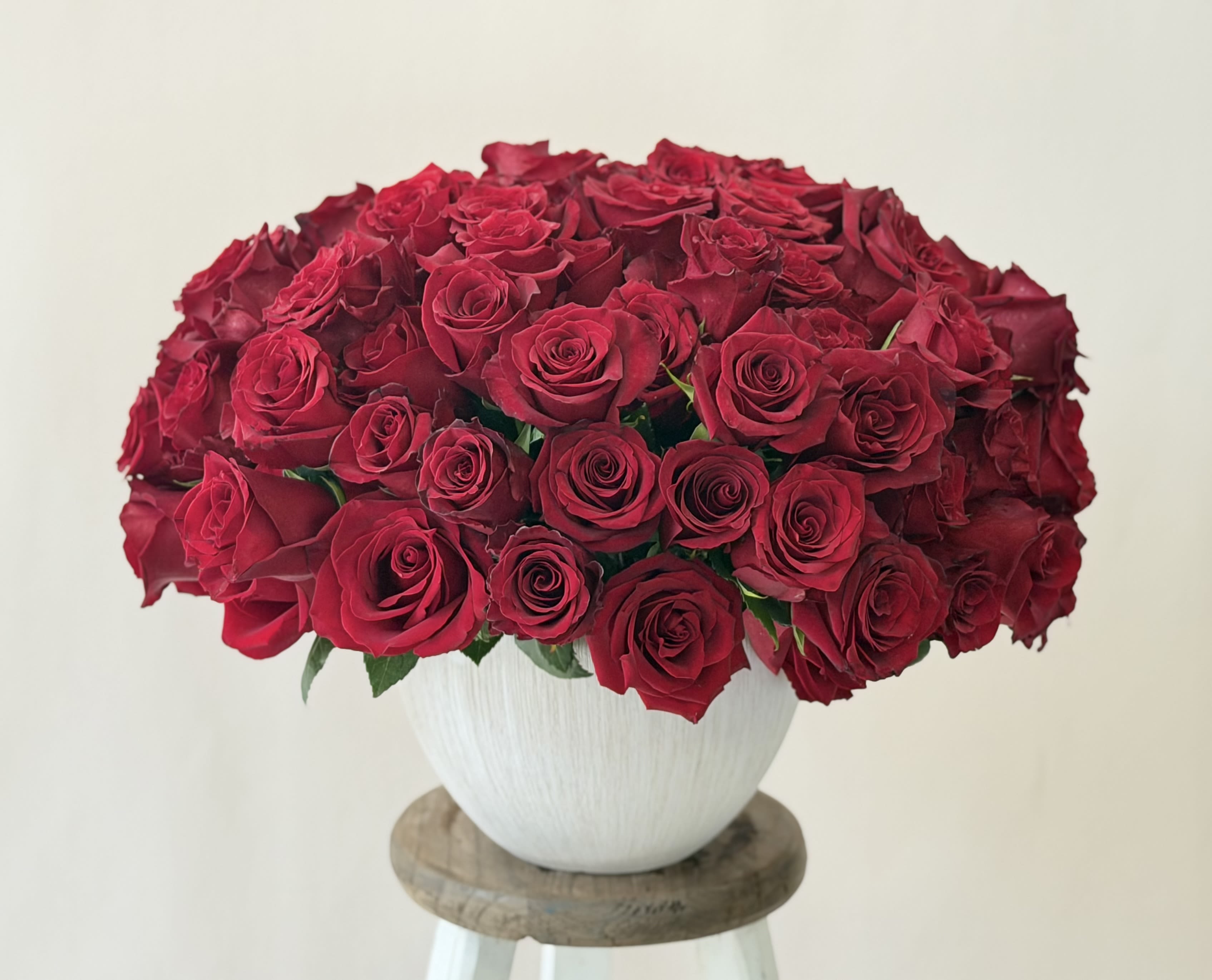 Large bouquet of red roses in a white vase