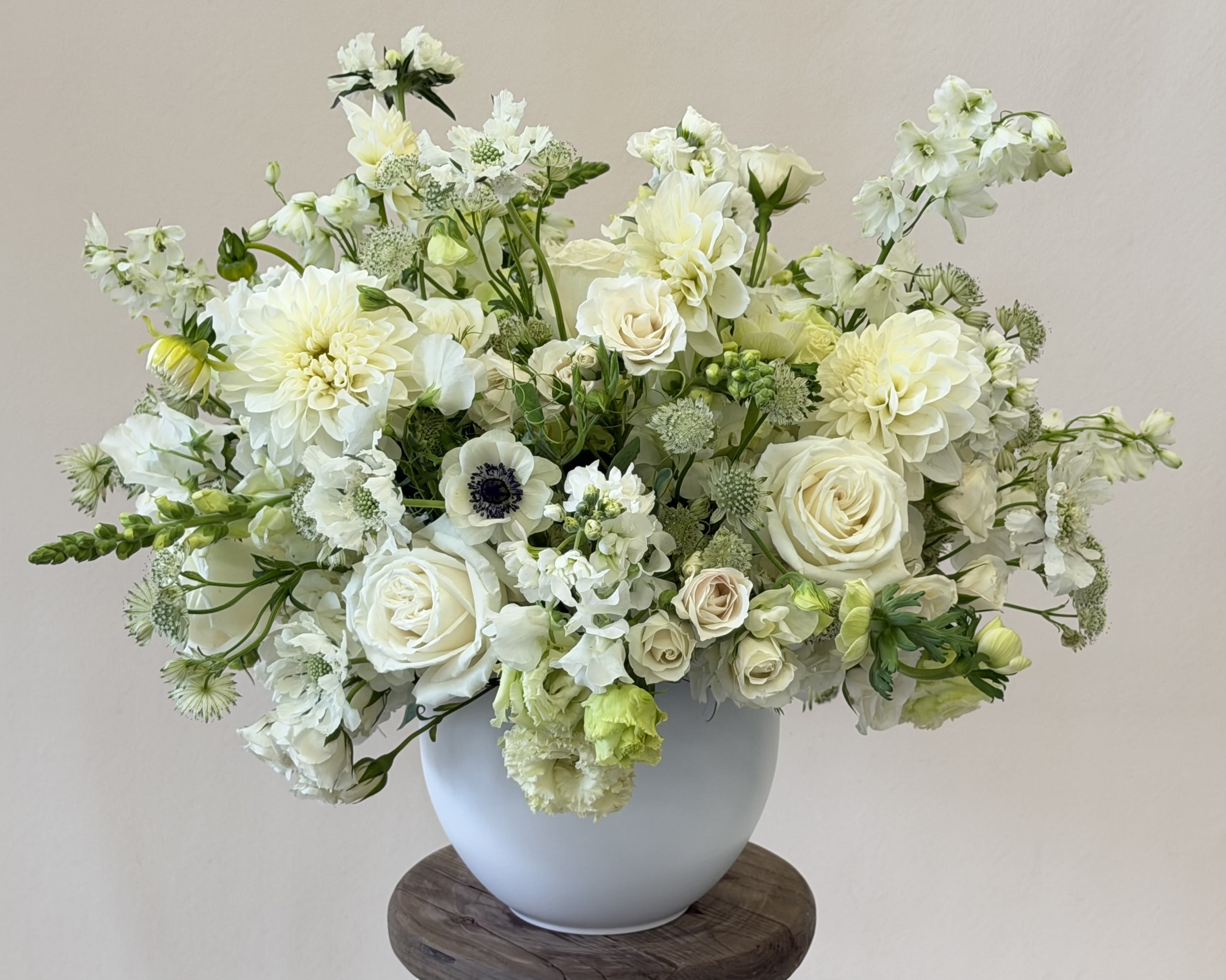 The All Right, All White arrangement - A bouquet worthy of royalty — and for anyone who simply wants to feel like one (let’s be honest, who doesn’t?). Luxurious layers of creamy white blooms that whisper elegance and grace.